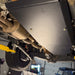 Underside view of the Juggernaut fuel tank skid plate mounted on a Ford Ranger Raptor