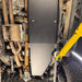 Close-up of the Juggernaut fuel tank skid plate mounting hardware and bracket points