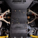 Close-up underbody view of the Juggernaut Ranger skid plate package showing plate seams and mounting hardware