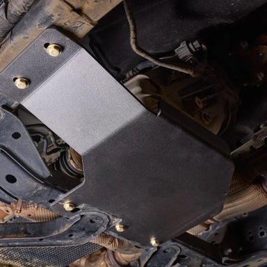 Close-up underbody view of the Juggernaut transfer case skid plate mounting hardware