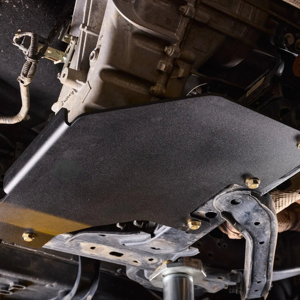 Ford Ranger Raptor on a lift showing the Juggernaut transfer case skid plate installed