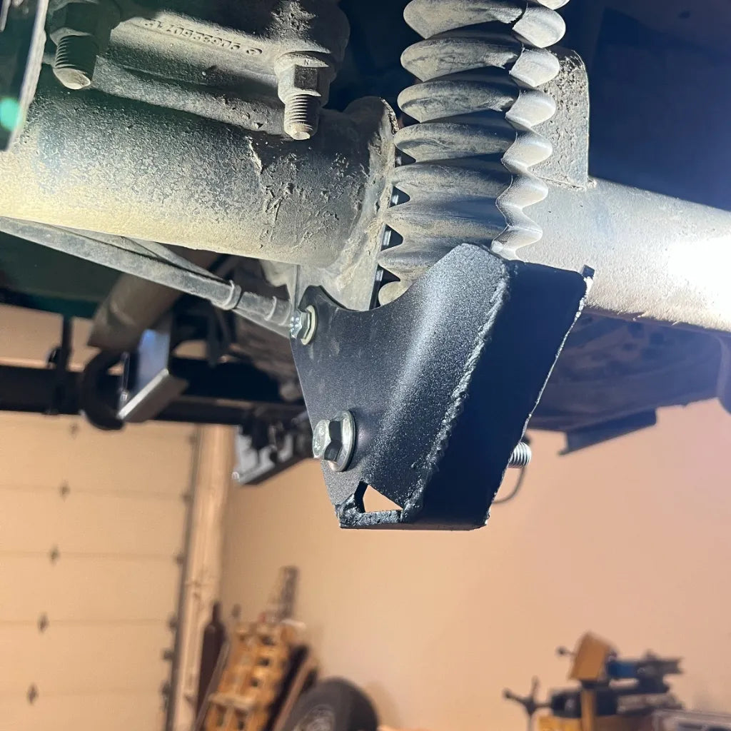 Juggernaut Mercedes Sprinter 4x4 rear shock skid plate installed at the rear shock mount