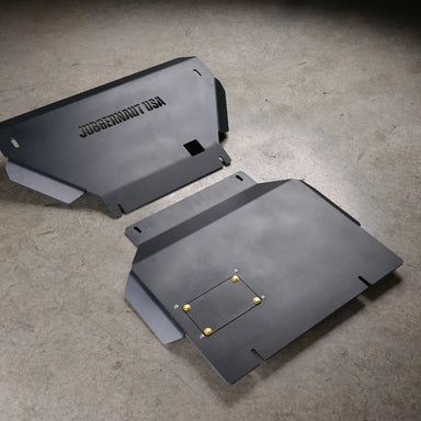 Juggernaut Tacoma engine skid plate, standalone product view on shop floor showing the embossed JUGGERNAUT USA logo