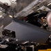 Underbody angle view of the transfer case skid plate mounted along the frame rail near the driveshaft