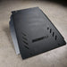 Juggernaut Tacoma transmission skid plate, standalone product view on shop floor showing the embossed JUGGERNAUT USA logo and slotted vent cutouts