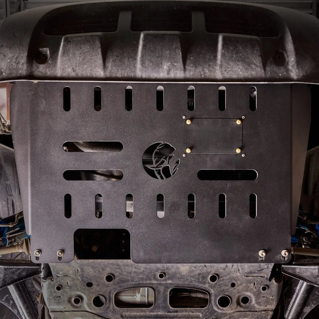 Ford Transit on a trail with the Juggernaut engine skid plate installed, front angle