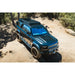 Land Rover Defender 110 on dirt trail with Leitner ACS ROOF platform rack, front angle