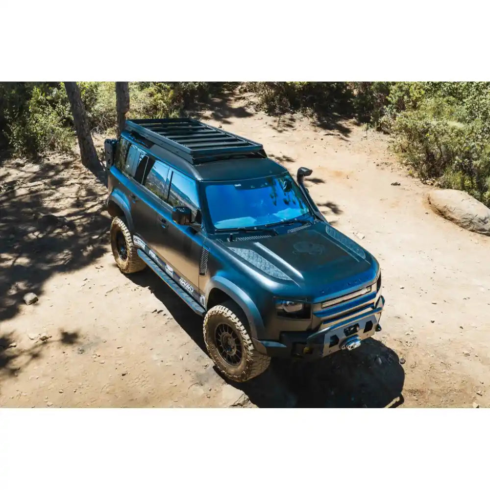 Leitner ACS ROOF rack on blue Land Rover Defender 110, front three-quarter view off-road