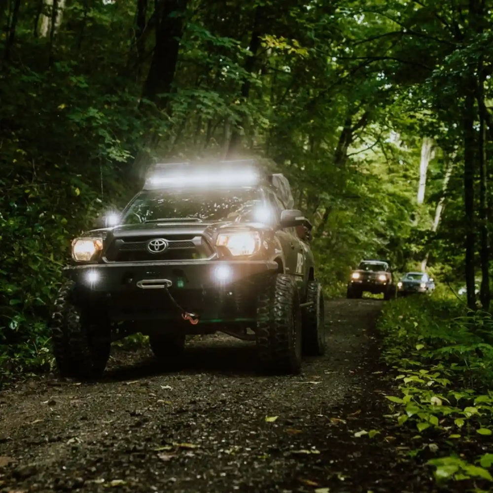 light bar illuminated on tacoma in the forest
