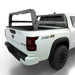 White Frontier with a black Shiprock bed rack on a white background