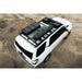Rago roof rack loaded with gear on white 4Runner, aerial rear close