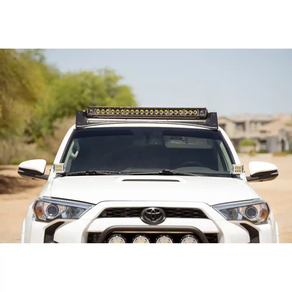 White 5th Gen 4Runner with light bar in Rago roof rack light pocket, front view