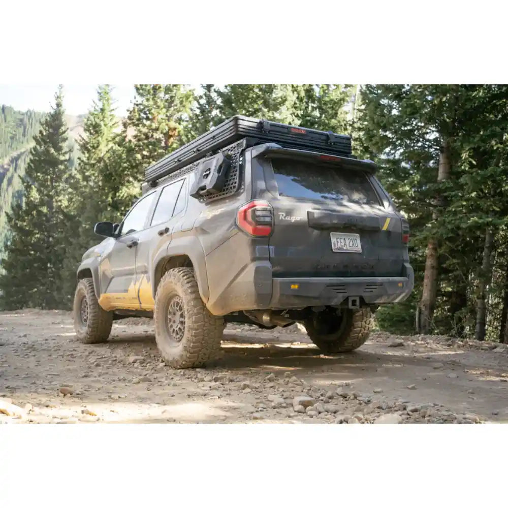 6th Gen 4Runner with Rago external Molle panels on trail, rear three-quarter