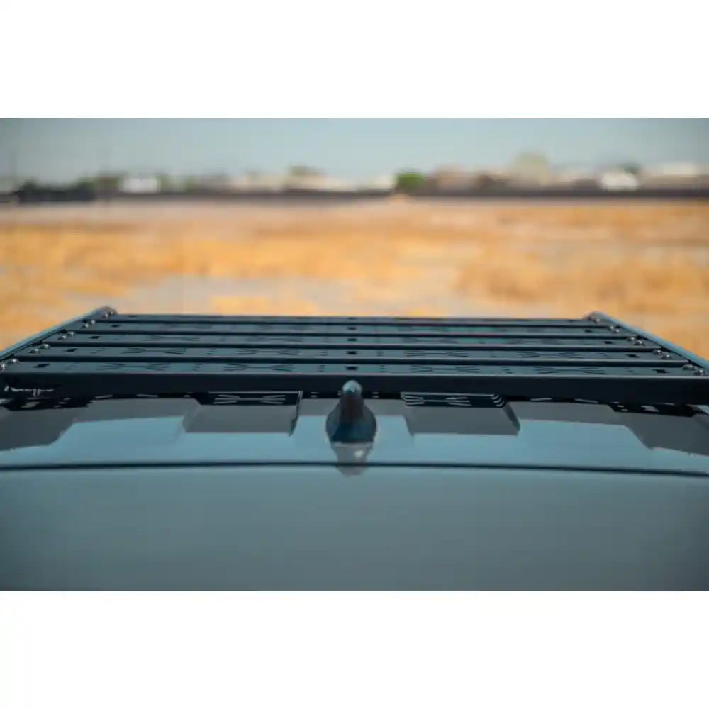 Low-profile Rago crossmembers on 4Runner roof rails, side view