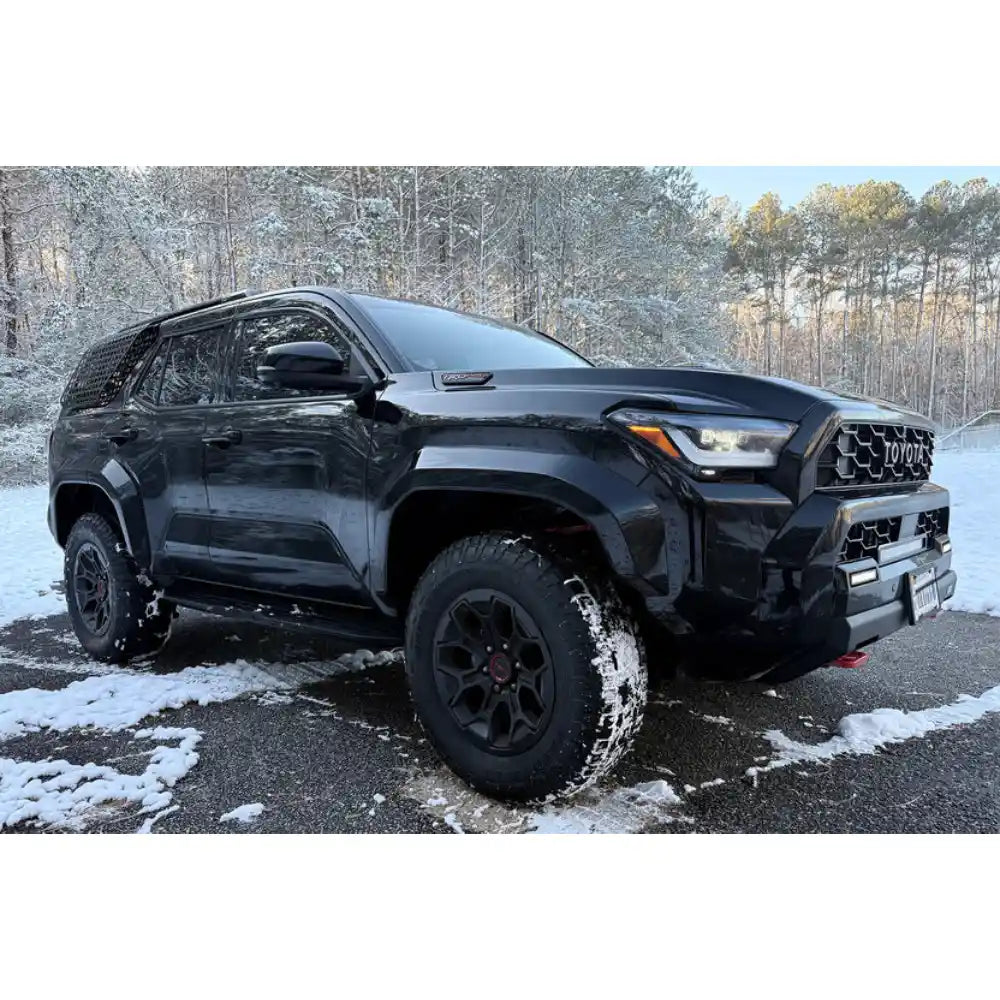 Black 6th Gen Toyota 4Runner with Rago roof accessories in snow
