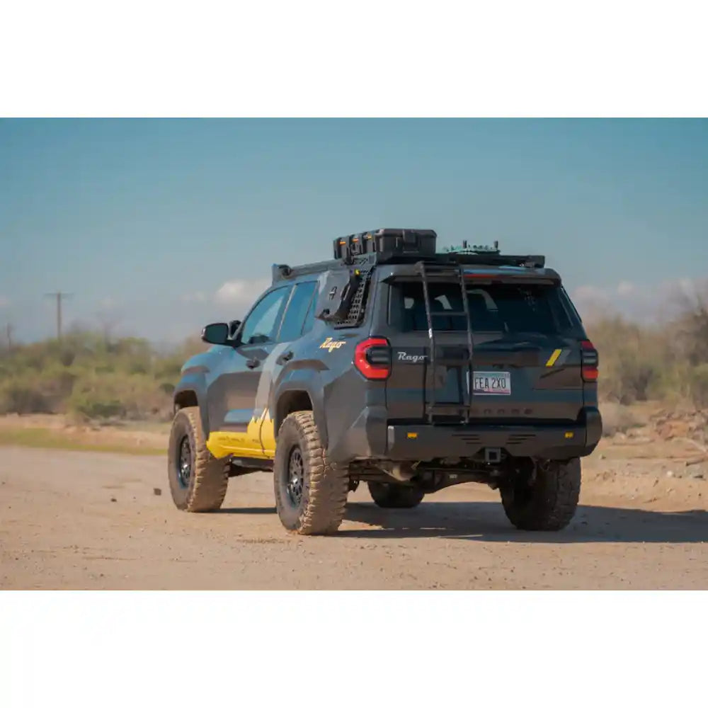 Toyota 4Runner with Rago rear hatch ladder on dirt road, rear three-quarter