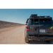 Toyota 4Runner with Rago hatch ladder on gravel road, rear three-quarter