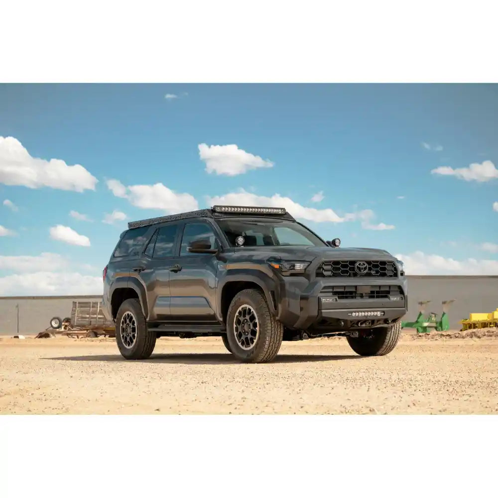 2025 Toyota 4Runner with Rago light pocket roof rack, front three-quarter in desert