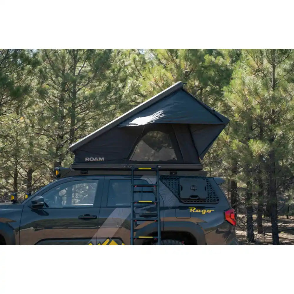 Rooftop tent on Rago 4Runner roof rack, side view in forest