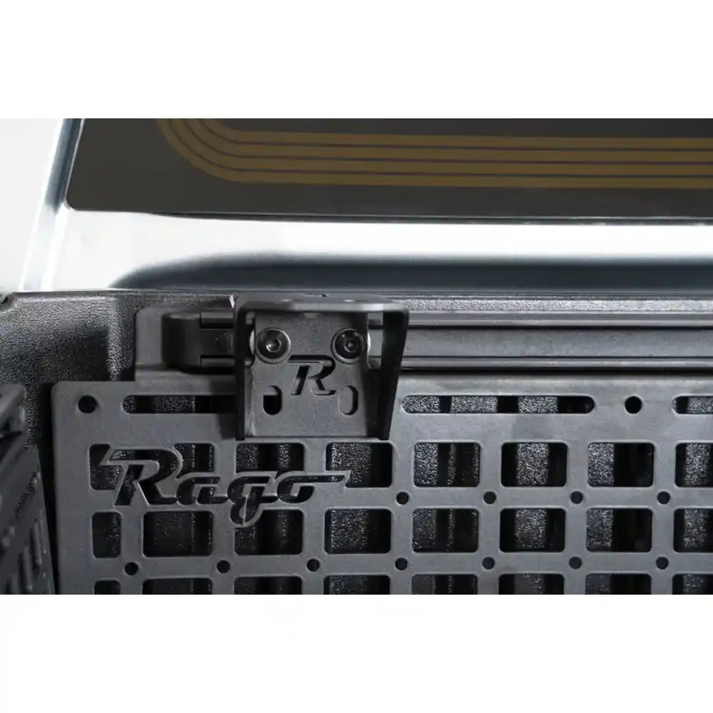 Rago accessory mounting bracket on Toyota cab bed rail, close-up