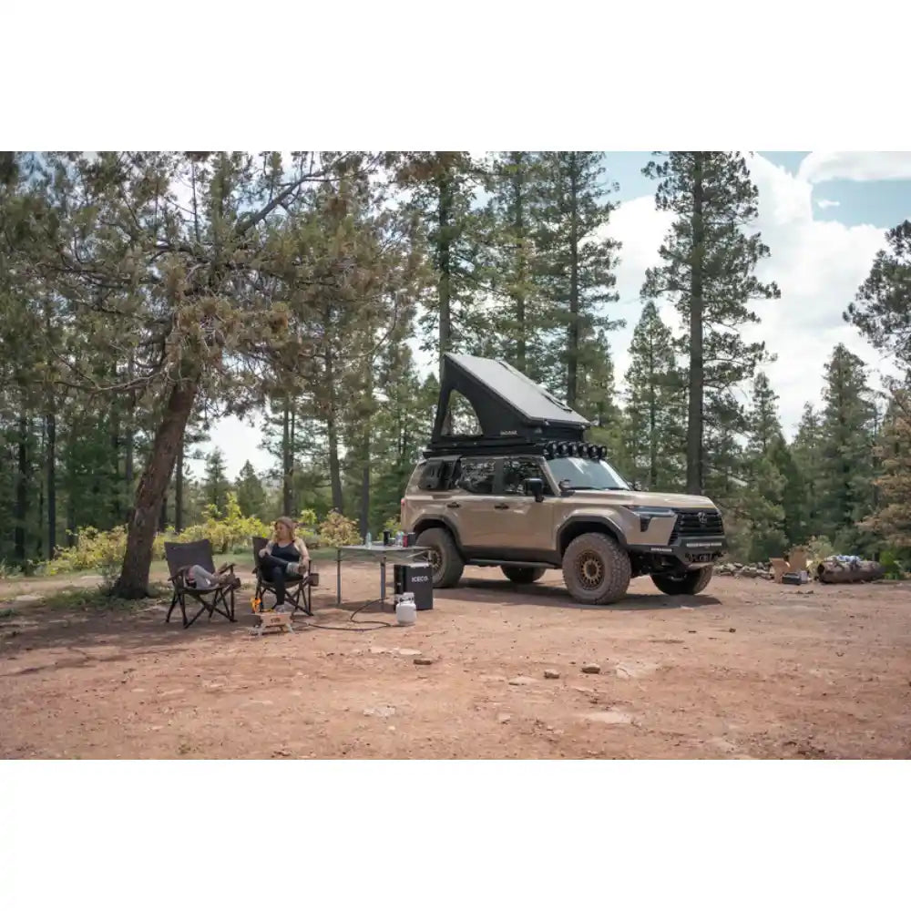 Lexus GX 550 camping in forest with Rago exterior Molle panels