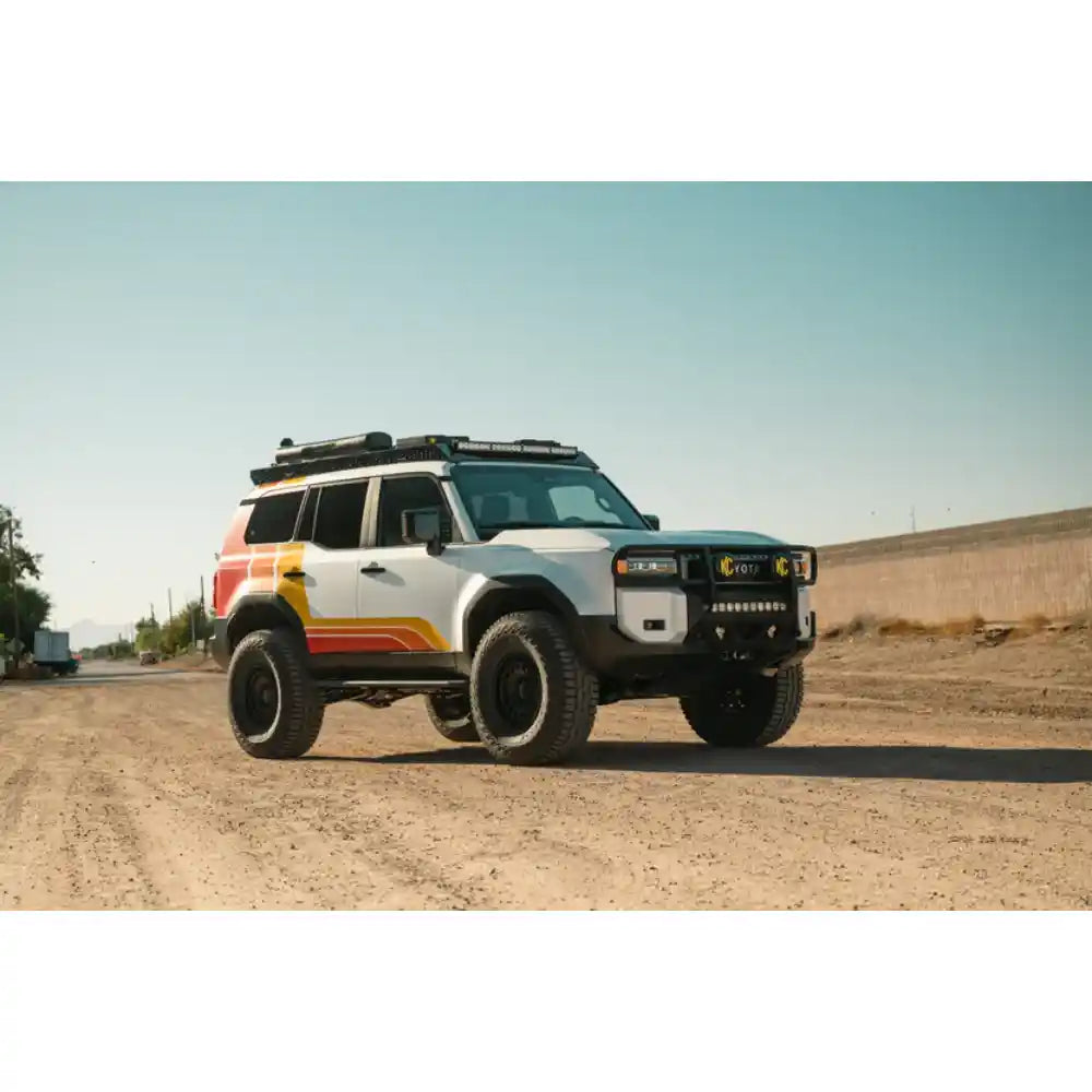 Land Cruiser with Rago roof rack and light bar, front three-quarter in desert