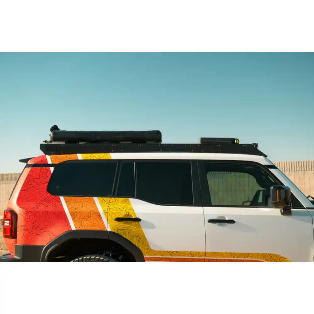 Toyota Land Cruiser with heritage livery and Rago roof rack, side view