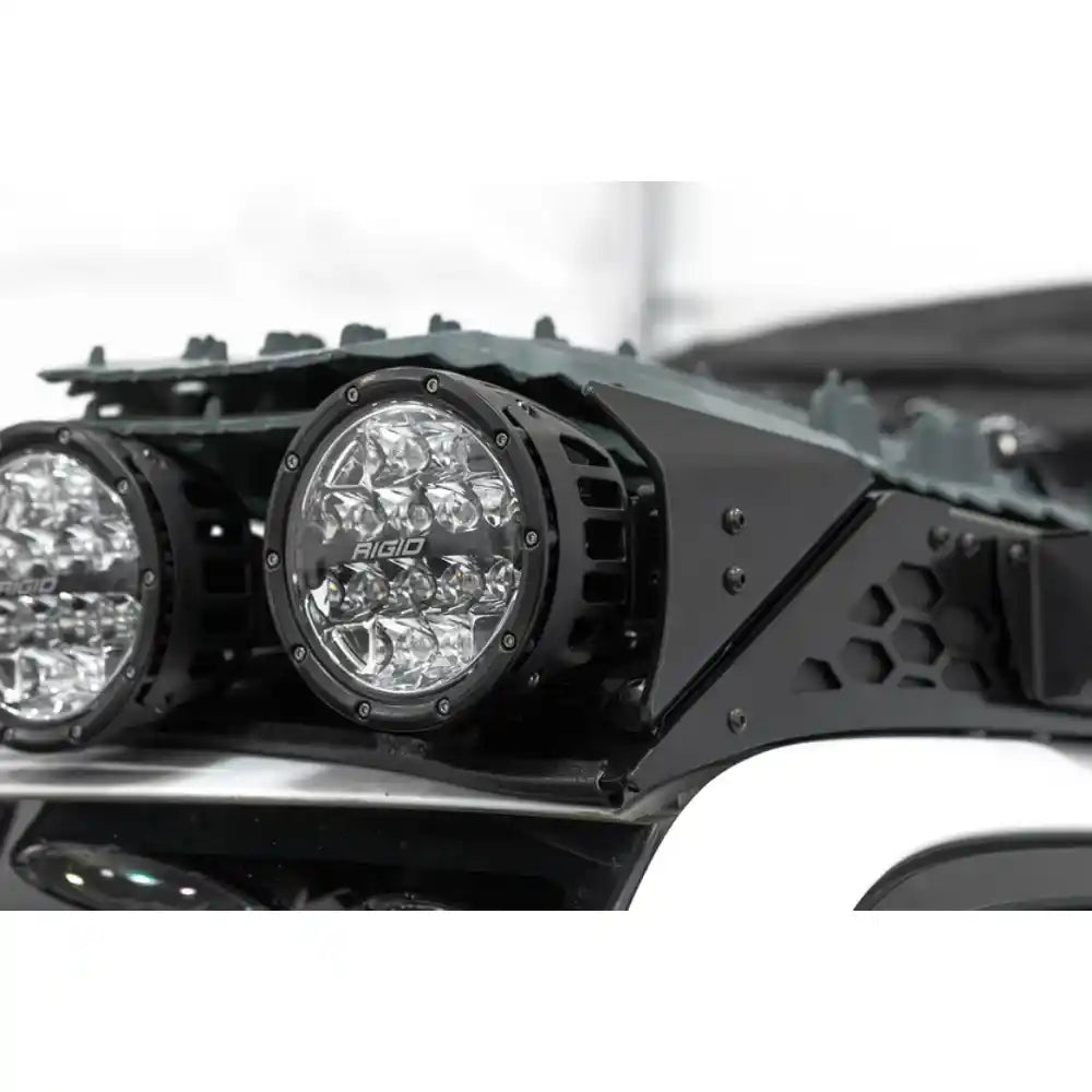 RIGID round lights on Rago roof rack front fairing, close-up