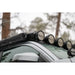 RIGID round lights on Rago roof rack light mount, Toyota Tacoma close-up in forest