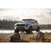 Toyota Tacoma by a lake with Rago round light mount on roof rack