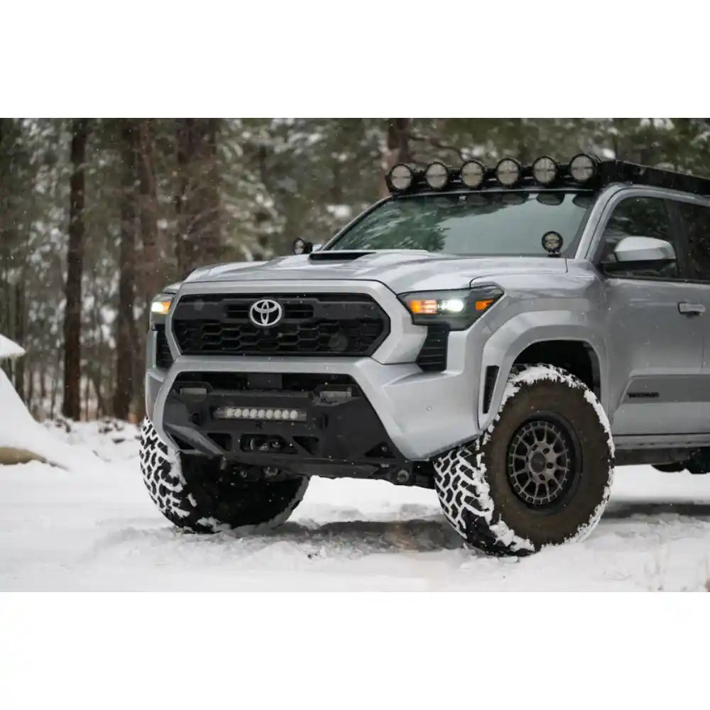 Toyota Tacoma in snow with Rago RIGID round light mount, front view