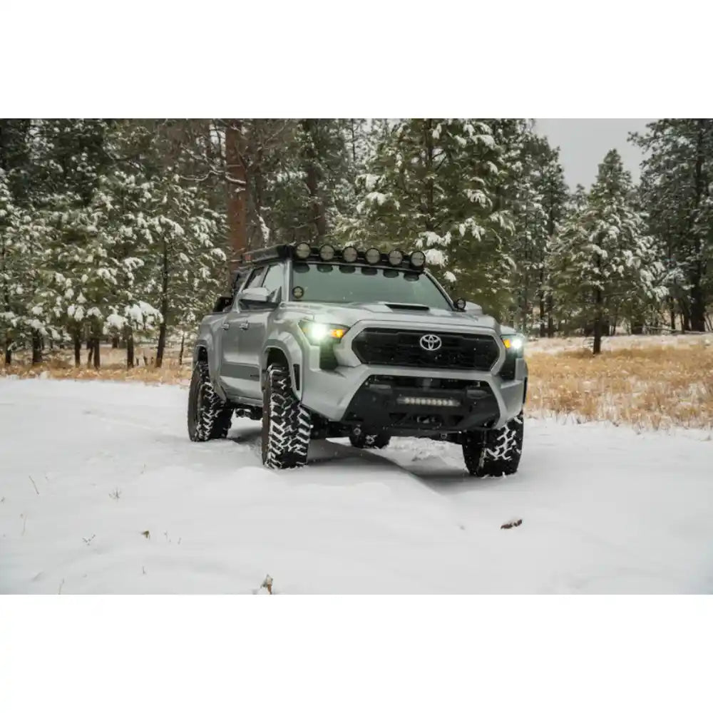 Toyota Tacoma with Rago round light mount in snowy forest