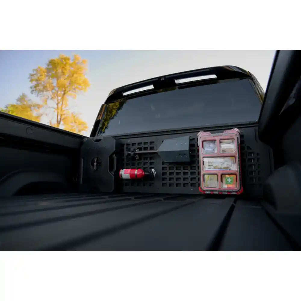 Rago Rivian bed cab Molle panel with gear, side angle