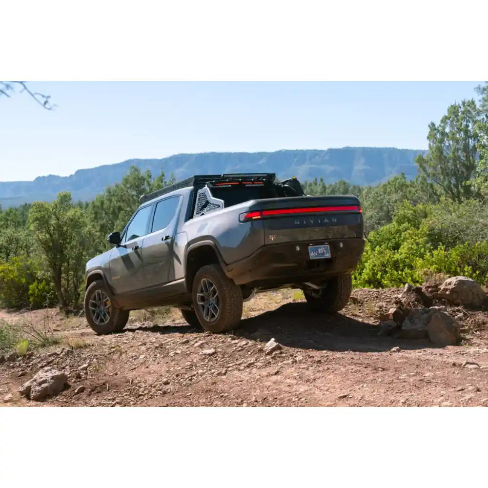 Rivian R1T with Rago chase rack off-road on rocks