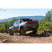 Rivian R1T with Rago chase rack off-road on rocks
