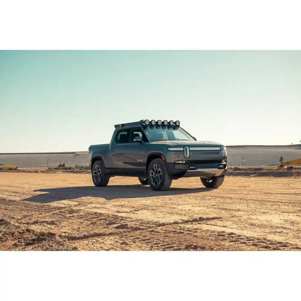 Rivian R1T with Rago RIGID light mount in desert, front three-quarter