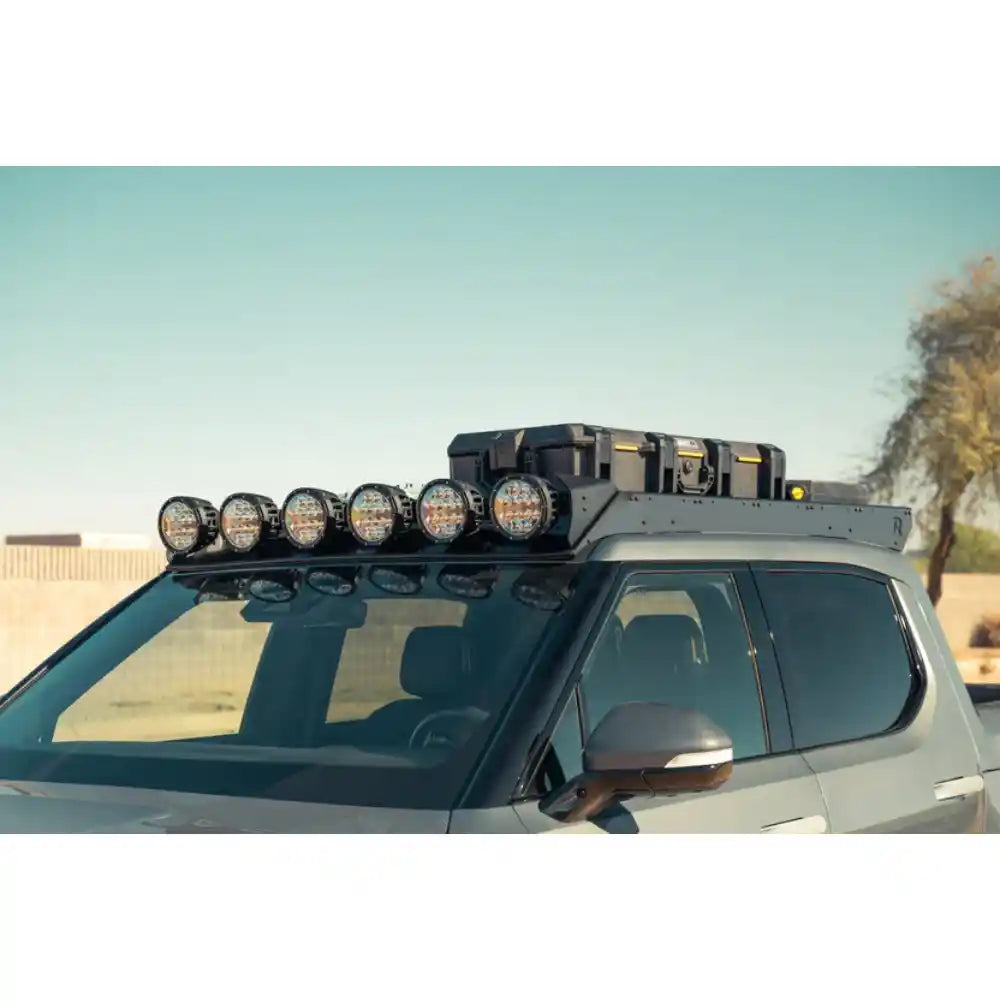 Six RIGID round lights on Rago Rivian R1T roof rack, front angle