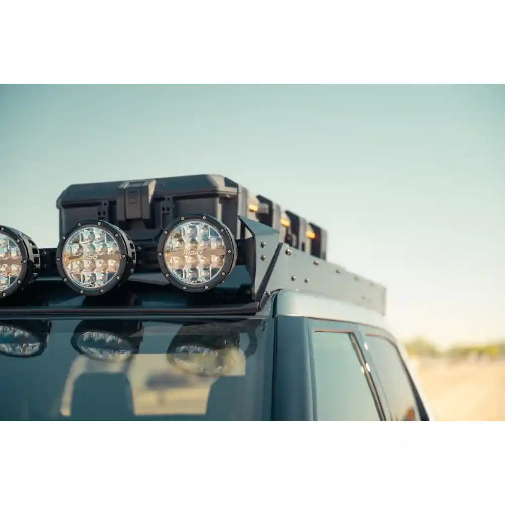 RIGID round lights on Rago Rivian roof rack mount, close-up