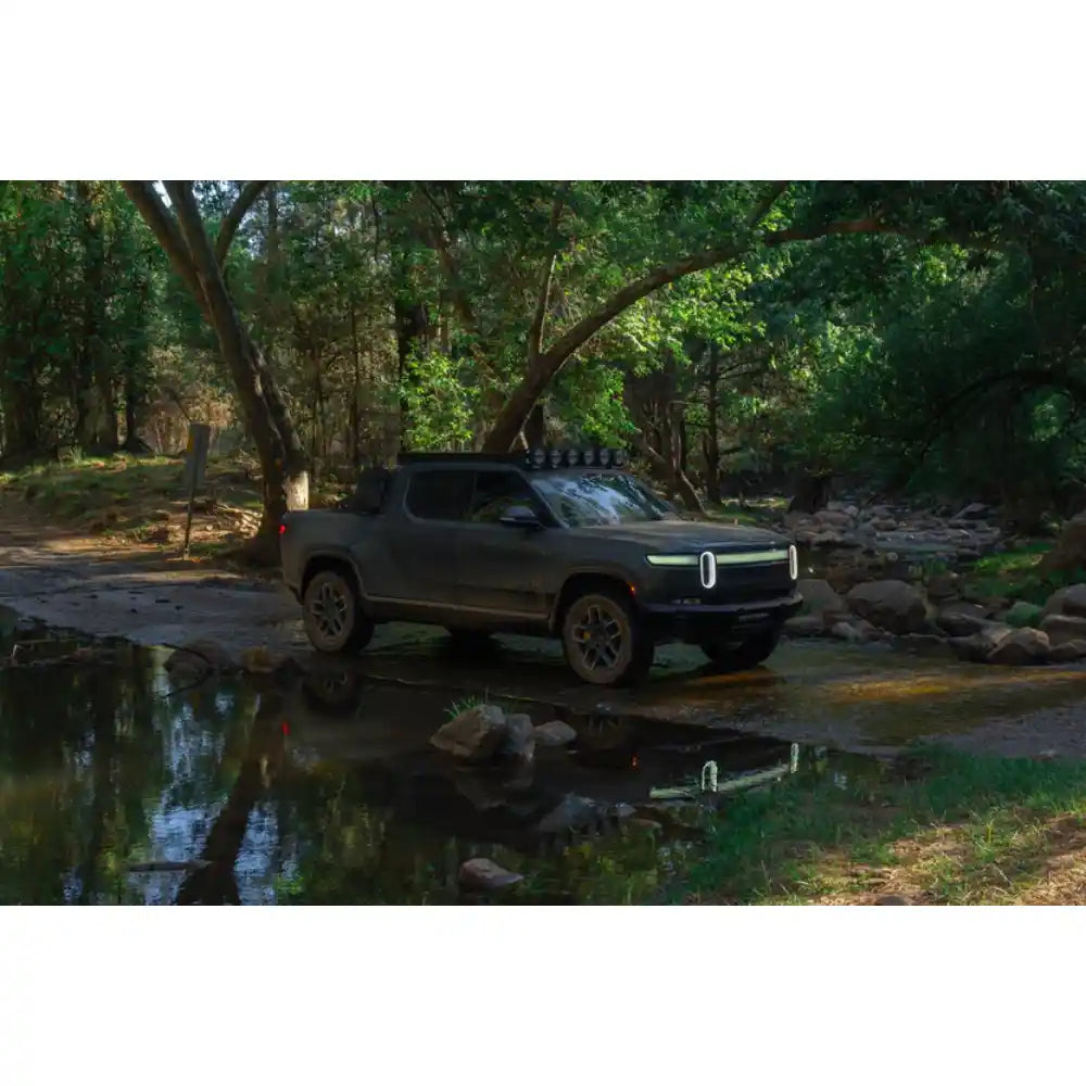 Rivian R1T with Rago roof rack crossing a creek