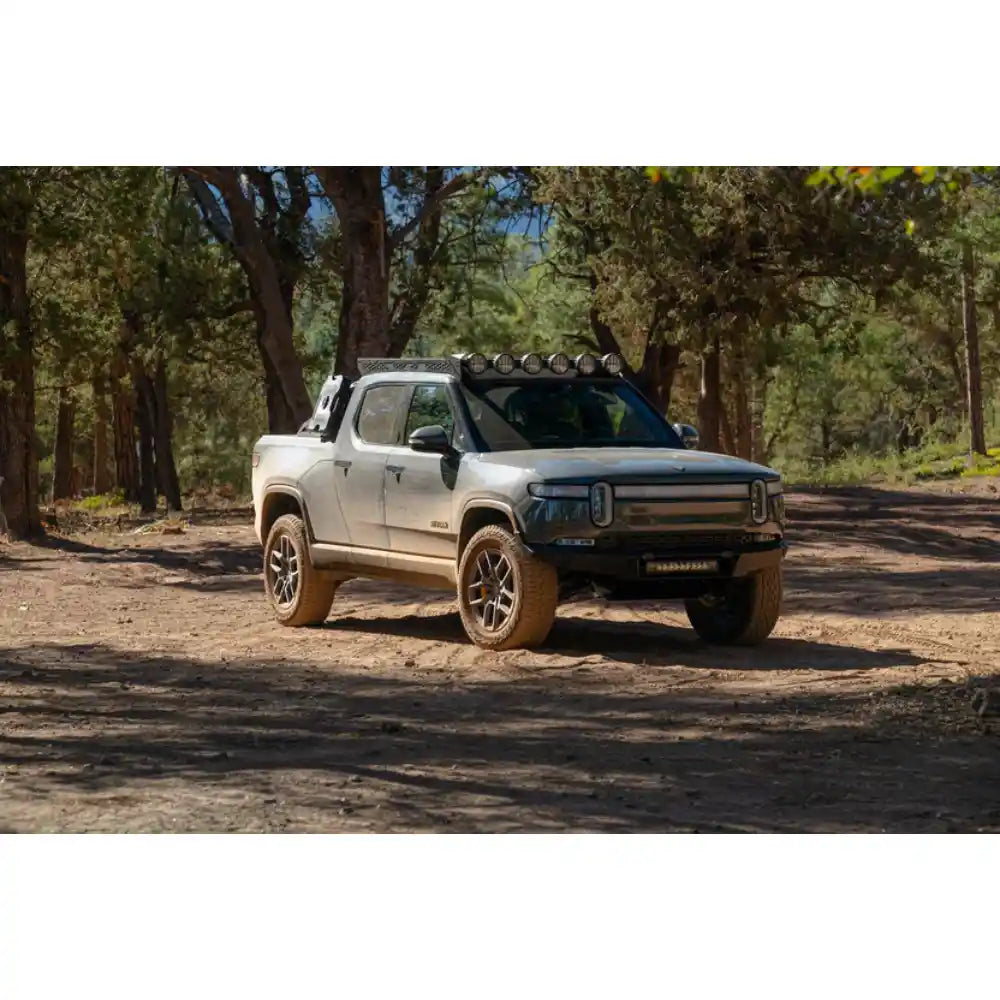 Rivian R1T with Rago roof rack on forest trail, front view