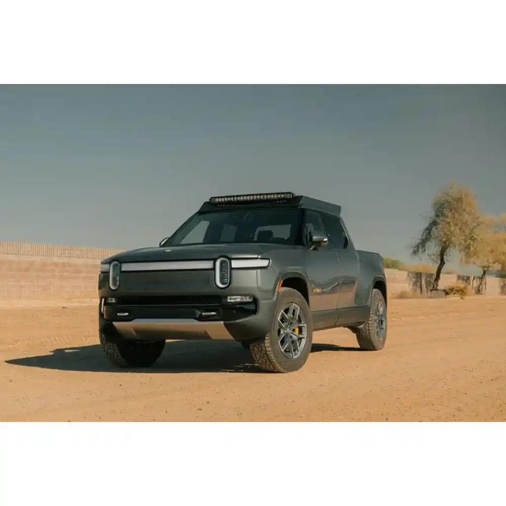 Rivian R1T with Rago light pocket roof rack, front view in desert