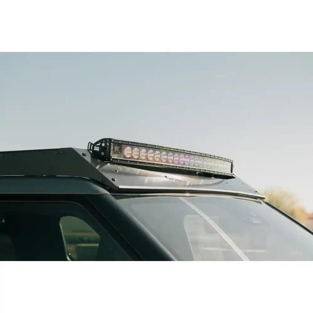 Light bar in Rago roof rack pocket on Rivian, low side angle