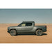 Rivian R1T side profile with Rago light pocket roof rack in desert