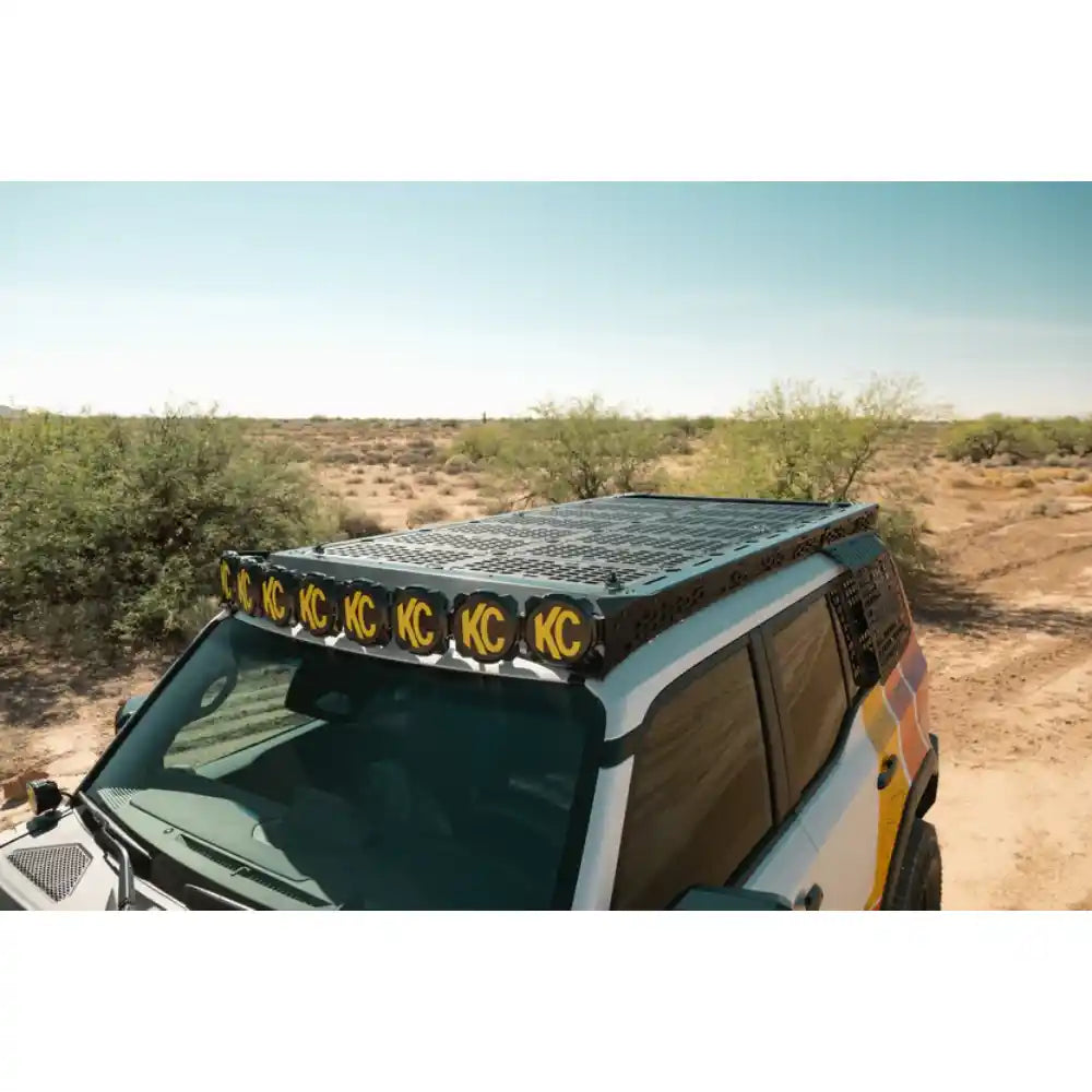 Rago decking panels and KC lights on Land Cruiser roof rack, side view