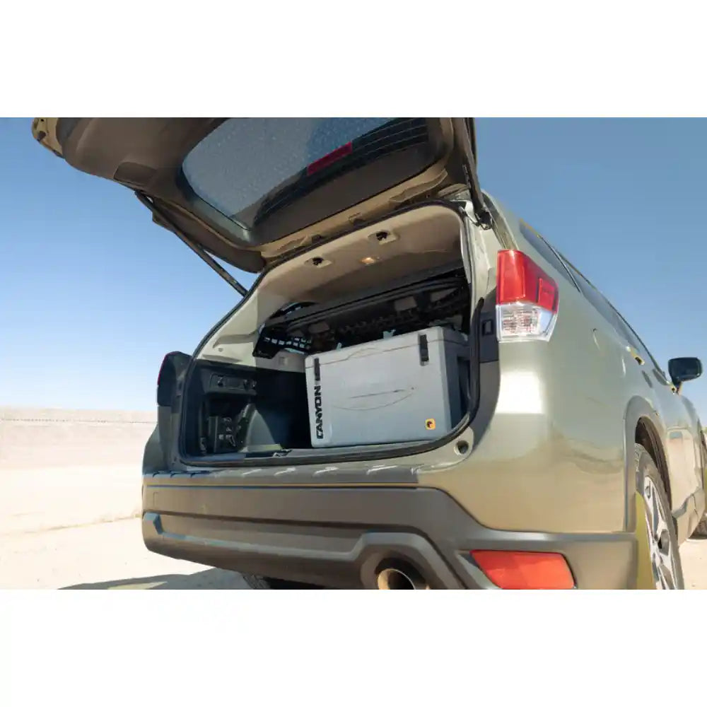Subaru Forester in desert with hatch open showing Rago Molle storage shelf