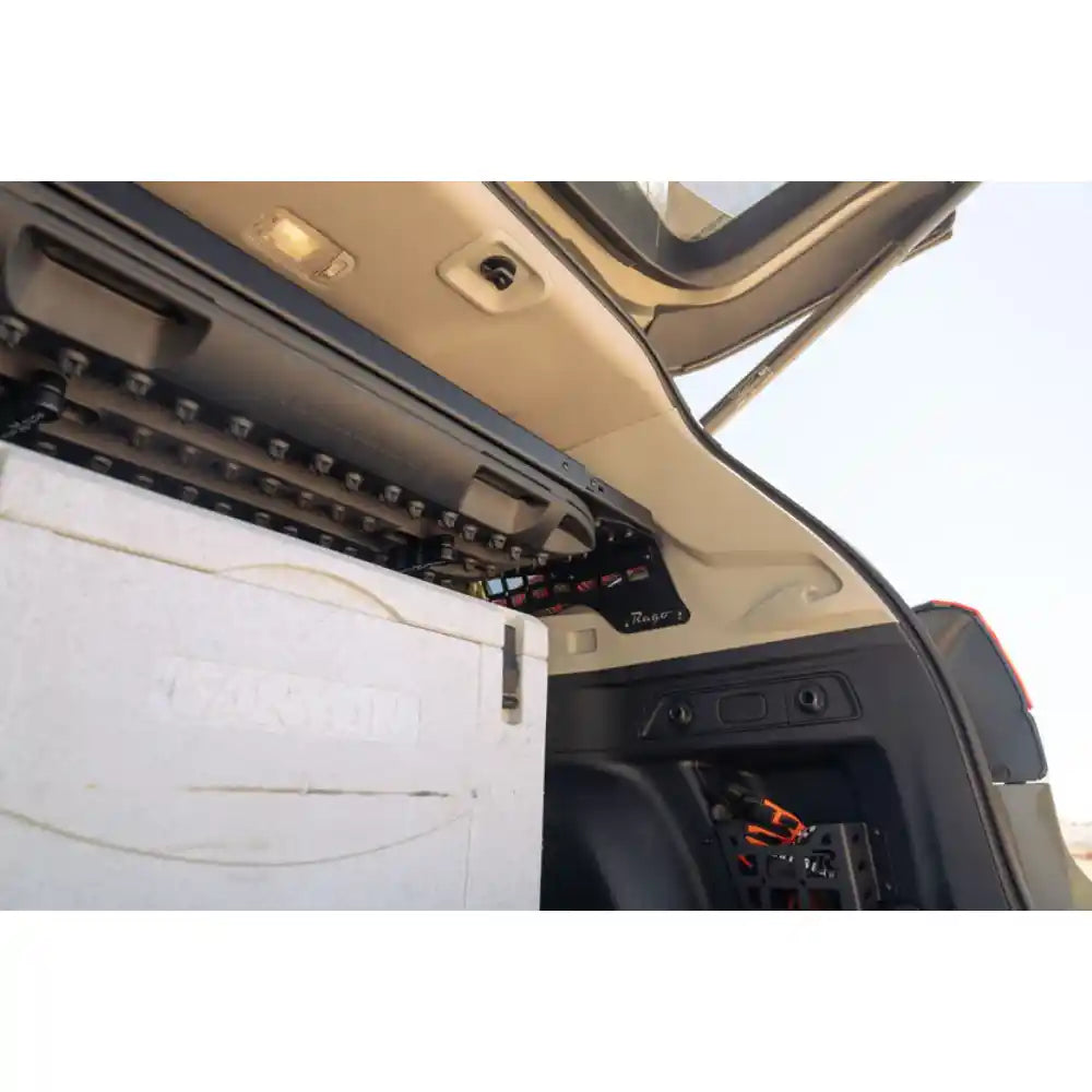 Rago storage shelf bolted to rear window Molle panel, Subaru Forester side view