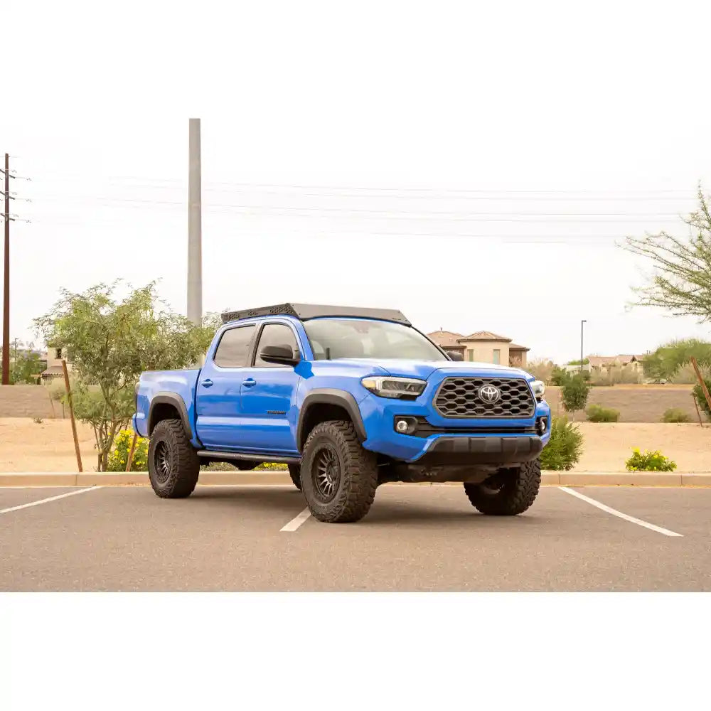 Blue 3rd Gen Toyota Tacoma with Rago roof rack, front three-quarter