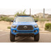 Blue 3rd Gen Tacoma with light bar in Rago roof rack, front view
