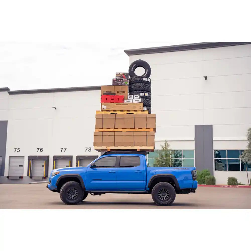 Rago roof rack load test on blue Tacoma, side view