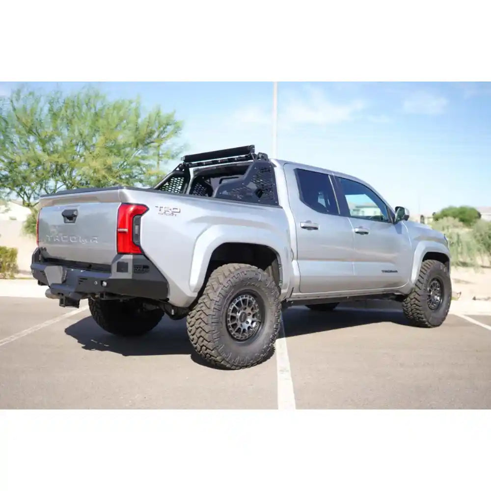 2024 Toyota Tacoma with Rago chase rack in desert, rear three-quarter